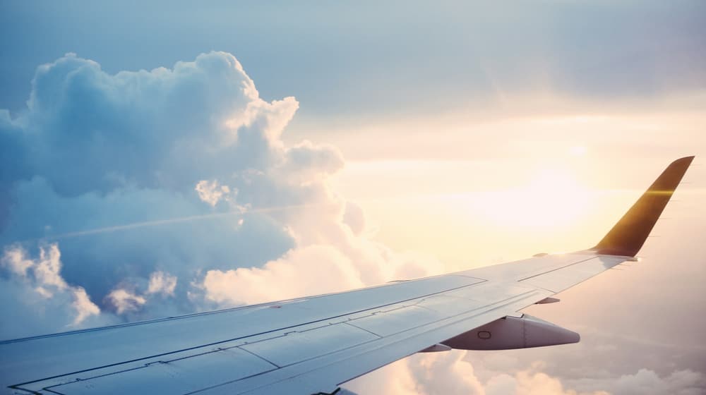 An airport terminal window with an aircraft outside