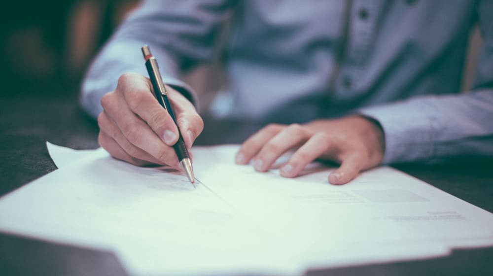 A person reviewing printed documents