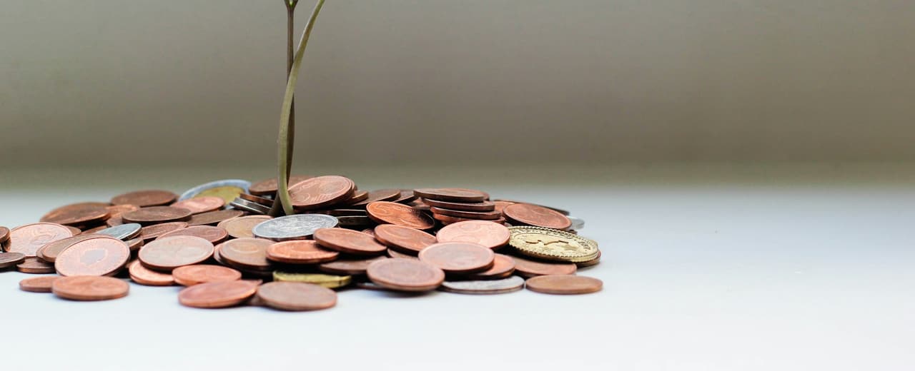 Coins stacked beside a calculator
