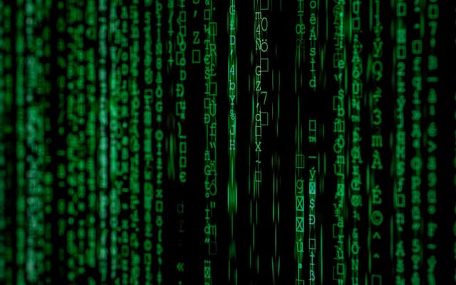 Streams of code on a dark monitor