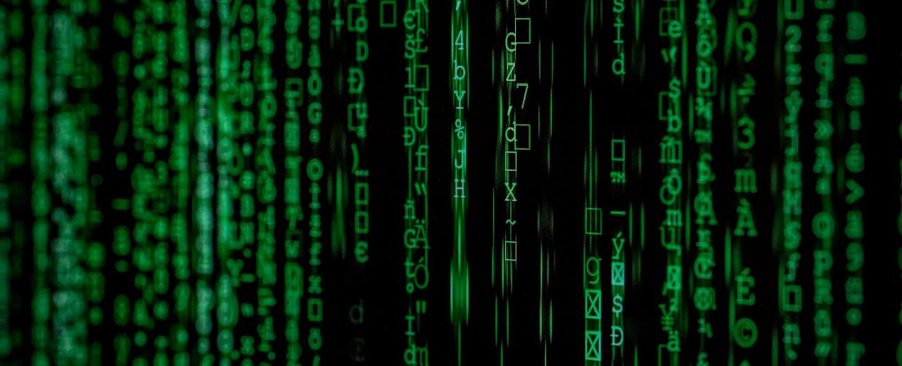 Streams of code on a dark monitor