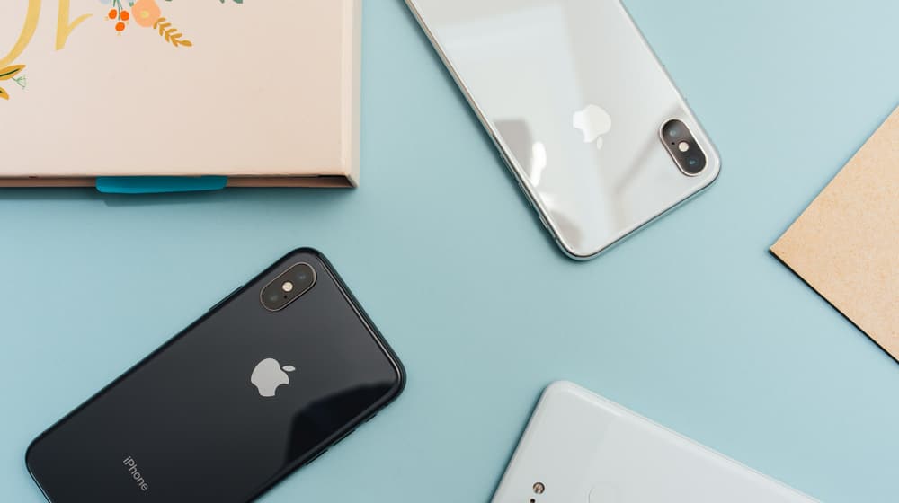 Several smartphones arranged on a desk