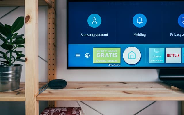 A smart TV home screen showing streaming apps
