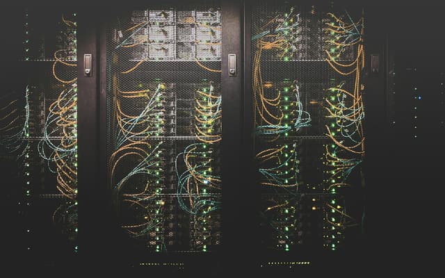 Racks of servers in a dark data centre