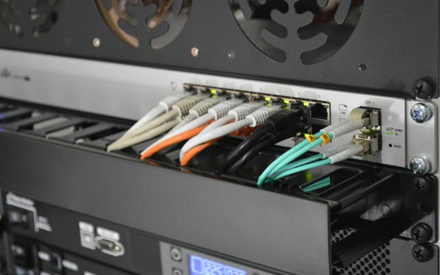 Fibre optic cables patched into a network switch