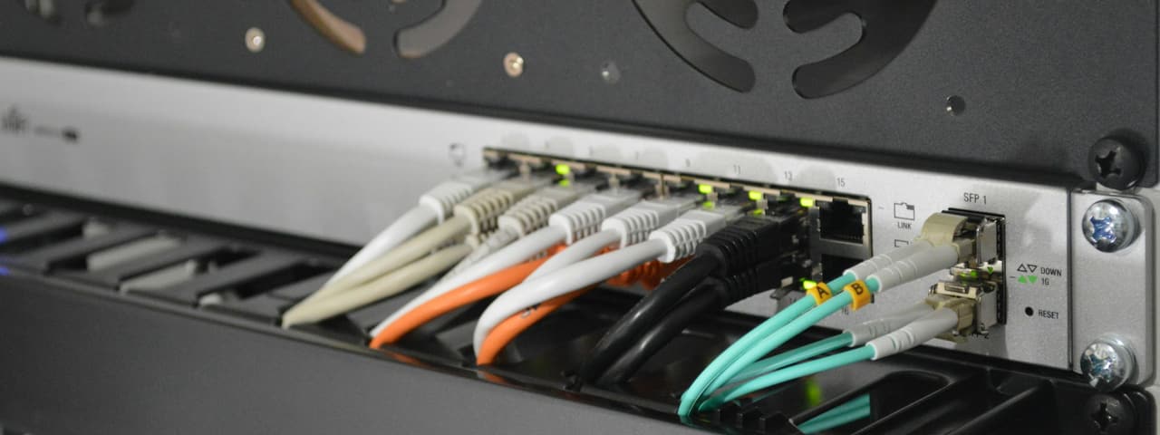 Fibre optic cables patched into a network switch
